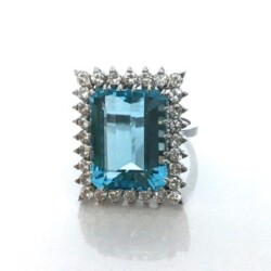 This stunning ring features a large rectangular aquamarine gemstone surrounded by a halo of sparkling diamonds, set in a sleek metal band. Perfect for jewelry collectors and those seeking a unique, elegant piece. Rings