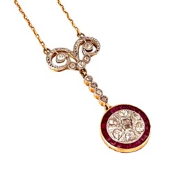 This exquisite diamond pendant features a circular design with sparkling diamonds and a vibrant ruby border, suspended from a delicate gold chain. Perfect for special occasions or as a luxurious gift. Necklaces