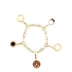 A close-up of a gold charm bracelet featuring various circular pendants, including a black stone, a logo charm, and open circle designs, displayed against a white background, highlighting its stylish and versatile jewelry design. Bracelets