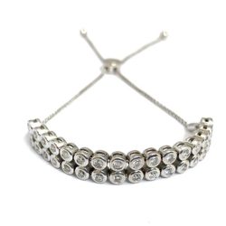 A stunning diamond tennis bracelet showcased in the Galleries collection, featuring a row of brilliant-cut diamonds set in a sleek silver band, perfect for adding luxury and sophistication to any jewelry collection. Bracelets