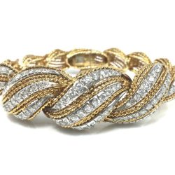 This luxurious gold and diamond twist bracelet showcases intricate craftsmanship, perfect for jewelry collectors and enthusiasts. Ideal for adding a touch of sophistication to any outfit, available for purchase or sale at our estate jewelry gallery. Bracelets