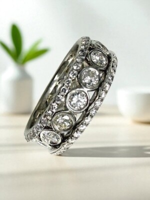 Elegant diamond eternity ring showcasing sparkling round diamonds in a luxurious platinum band. Shiny diamond eternity ring with multiple round-cut diamonds in platinum setting.