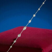 Luxurious diamond necklace featuring alternating marquise and round cut diamonds set in a fine silver chain, showcased on a red velvet cushion. Ideal for those seeking high-quality estate jewelry, perfect for investment, gifting, or personal adornment. Elegant diamond necklace with alternating marquise and round cut diamonds set in a delicate silver chain, displayed on a luxurious red velvet cushion against a deep blue background. Perfect for jewelry collectors and investors.